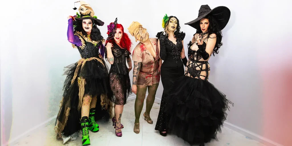 booudoir performers posing together at Revelry Pompano Beach during a Halloween event, dressed in halloween costumes